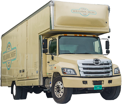 Cream-colored William C. Huff moving truck with logo isolated on a black background