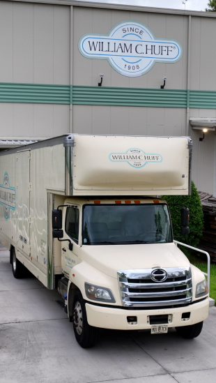 William C. Huff moving truck parked in front of a William C. Huff storage facility