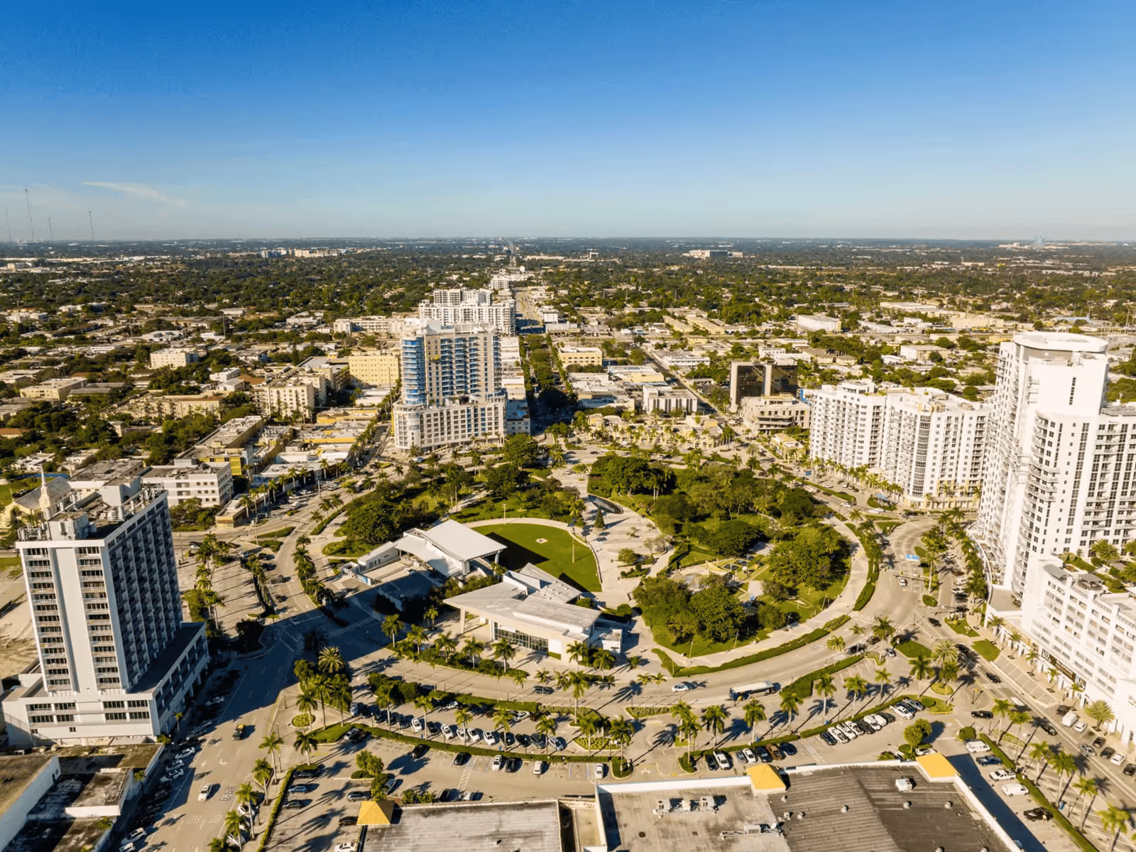 Aerial view of Young Circle Park in Hollywood, Florida, surrounded by city buildings and lush greenery.